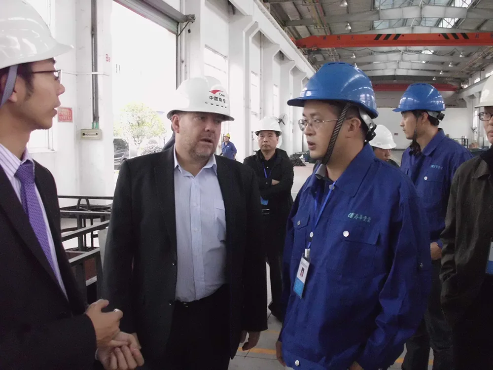 Changjiang and FMG delegation members speaking with Chunhua staff in the forging workshop