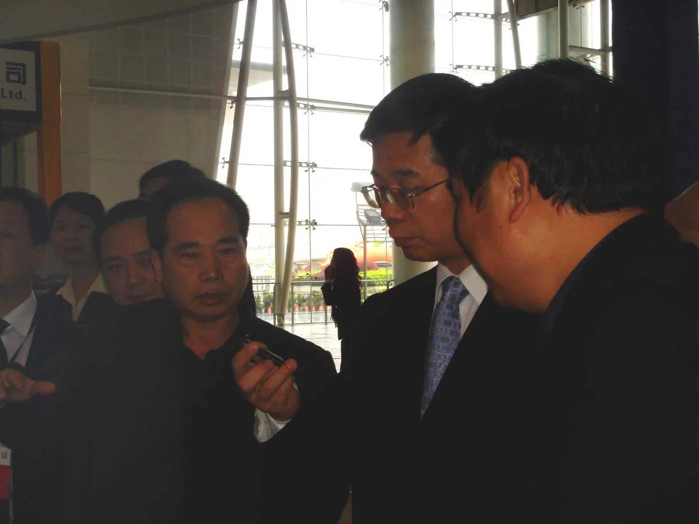 Visitors examining a component at Chunhua’s exhibition display