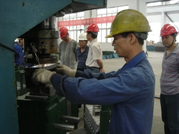 Competition scene one: a Chunhua employee operates workshop equipment while colleagues observe